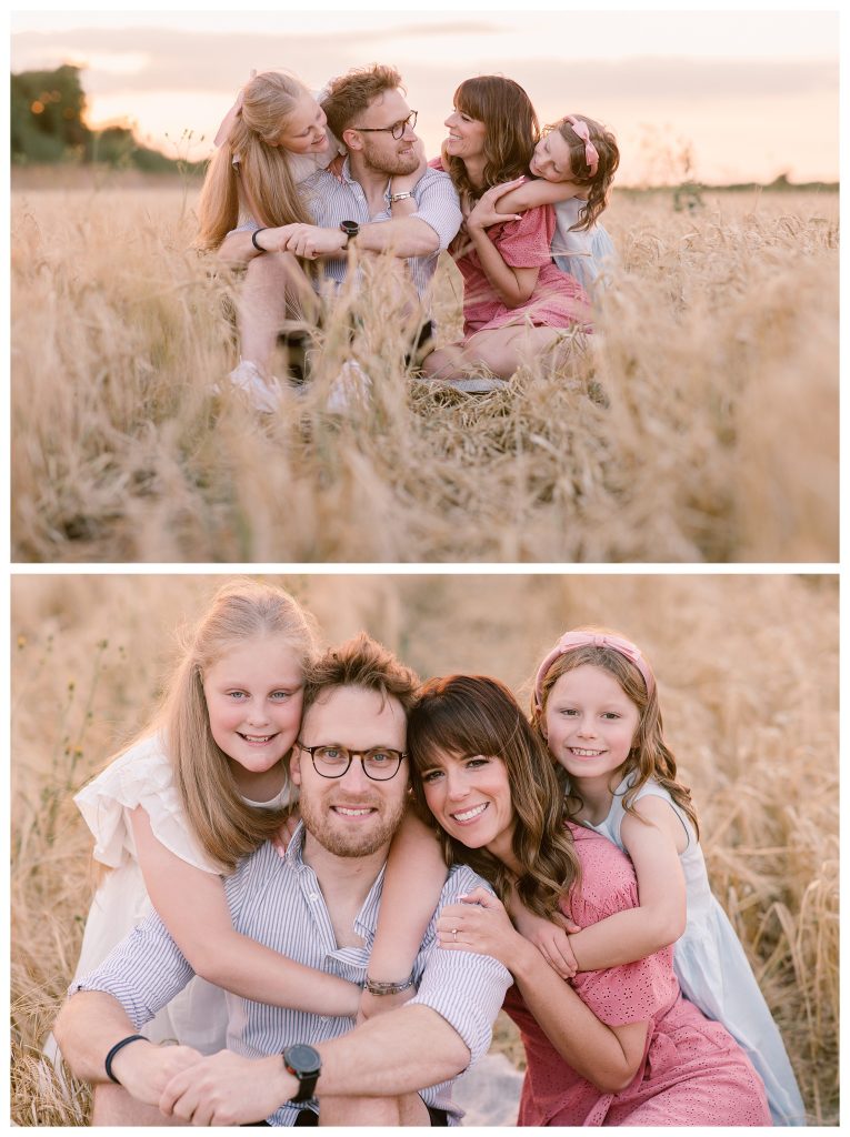 golden hour family shoot in Hampshire with Hampshire Photographer Lucylou Photography captures a natural golden hour moment of a blended family sitting in a wheat field at Meon Shore. Parents Elliott and Chantelle sit close, smiling at each other, while their daughters lean in with hugs and laughter in soft evening light