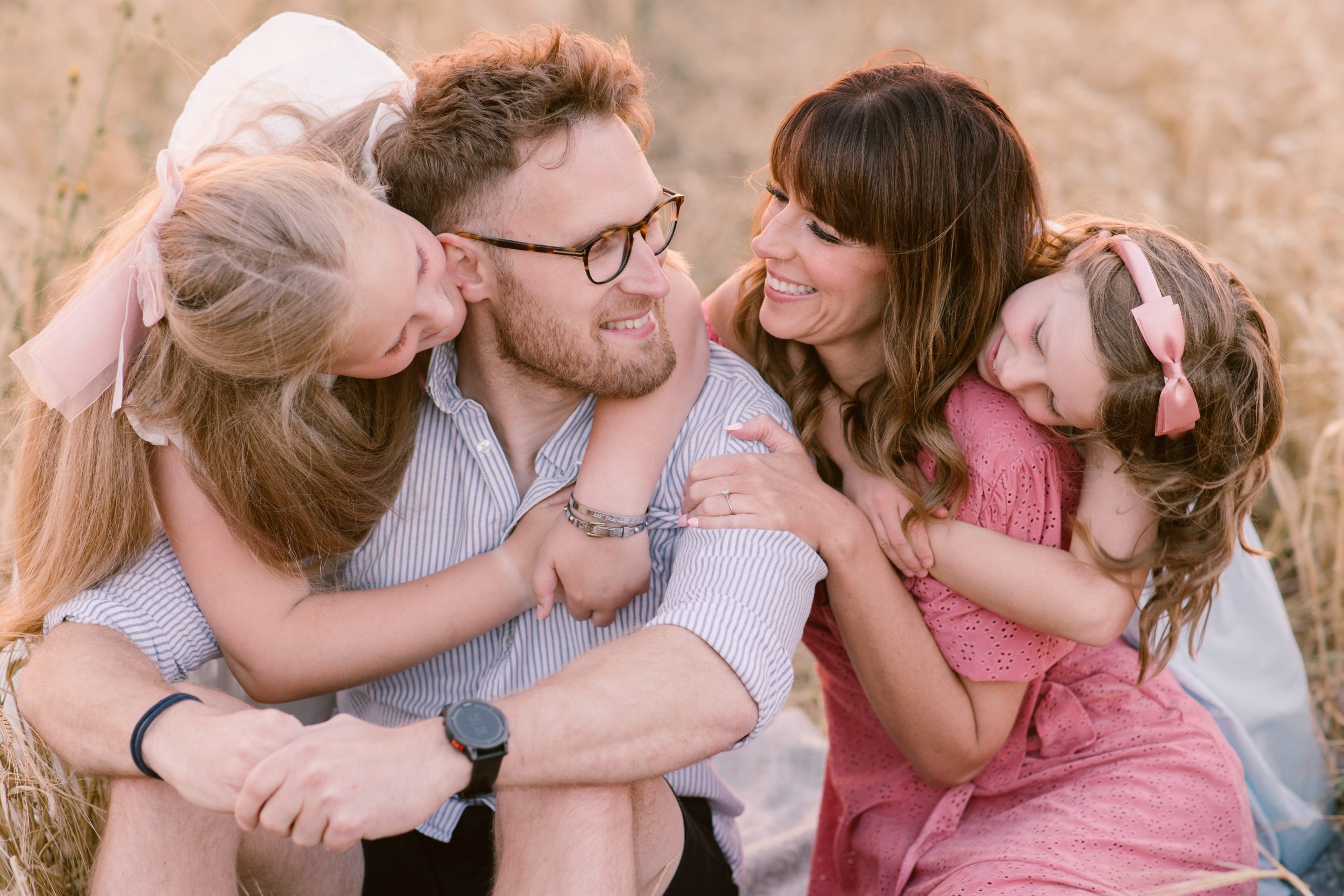 Professional Family Photos with young children cuddling their mummy and daddy, showing love and connection